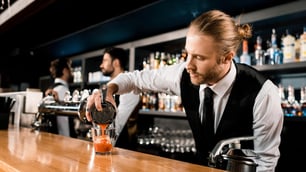 Bartender puring drink