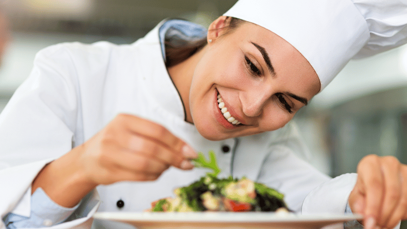 A chef presenting high quality food on a plate